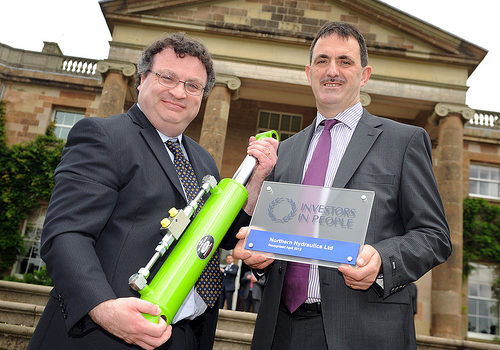 Minister Farry congratulates Seamus Morris of Coalisland’s precision engineering organization Northern Hydraulics on being awarded the prestigious Investors in People (IiP) accreditation