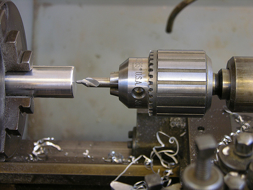 Employing the metalwork lathe, turning down, taper turning, drilling, knurling and threading making use of taps and dies.