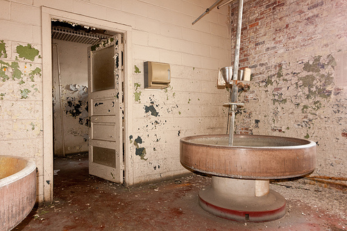 Bathroom with big round sinks aka. Bradley Washfountains. Abandoned Barber-Colman factory in Rockford, Illinois