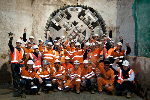 Workers in front of tunnel boring machine