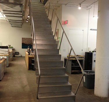 Blackened steel stair with stainless treads